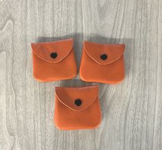 "This orange/tangerine color small coin purse is made of genuine leather, great color for fall.  Last picture is just a demo of another one.  .   They are on the thinner medium side, not a bit bulky.  Some might have range markings on them,  but that's only natural.    They may be small but it's handy to put in your purse, or front or back pocket to carry small change for parking meters, cones, some even use for ear buds, hearing aids, etc. Black metal snap snaps easy.     I put a rivet on each side toward top to strengthen, along with stitching.  About   2-3/4\" wide  across bottom, 2-1/2\" wide across top x 2 -1/2\" high closed.    Price is for one coin purse.   I have more of these coin purses in my other pages, you can click on leather coin purse on my home page to see all the coin pur Leather Coin Purse As Gift, Leather Coin Purse For Gift, Leather Coin Purse With Smooth Grain As Gift, Brown Soft Leather Coin Purse As Gift, Leather Coin Purse With Removable Pouch As Gift, Gift Brown Soft Leather Coin Purse, Brown Soft Leather Coin Purse Gift, Leather Pouch With Coin Pocket As Gift, Leather Coin Pocket Pouch As Gift