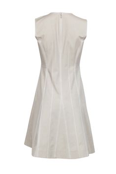 Form meets function in this sleeveless beige dress by Lafayette 148. Eye-catching contrast stitching is the focal point, elevating this simple piece into wardrobe staple. Wear with sneakers in the summer months, or knee-high snake skin boots in the fall for a truly stylish look. Size 2 66% Cotton, 25% Polyamide, 9% Elastane Rounded collar w/ v-opening Concealed back zipper Contrast stitched pleats Bust 36" Waist 29" Shoulder to hem 37" White Sleeveless Dress With French Seams, Fitted Summer Dress With Contrast Stitching, Fitted Summer Dress With Seam Detailing, Chic Spring Dress With Seam Detailing, Neutral Fitted A-line Dress, Beige A-line Sleeveless Cotton Dress, Beige Cotton A-line Sleeveless Dress, Fitted Beige Sleeveless Dress For Work, Snake Skin Boots