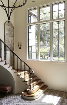 a staircase leading up to a large window