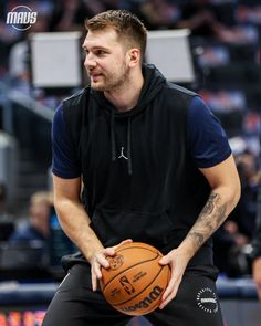 a man holding a basketball in his right hand