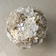 a bouquet of flowers sitting on top of a floor next to a tile flooring