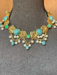 Vintage gold choker with round turquoise and green cabochons and dangling pearl and turquoise bead accents  Unsigned  17" end to end with adjustable hook closure Open filigree type metal work on the gold tone  Excellent condition, no missing stones or pearls See pictures for additional details Adjustable Gold Turquoise Necklace For Festivals, Vintage Gold Beaded Turquoise Necklace, Festoon Necklace, Necklace With Pearls, Bib Necklaces, Brass Necklace, Gold Choker, San Rafael, Metal Work