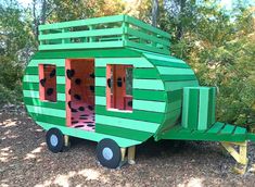 a green and yellow trailer shaped like a house