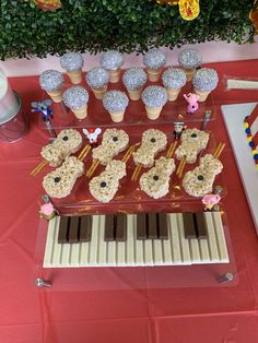 an ice cream sundae is on a table with cupcakes