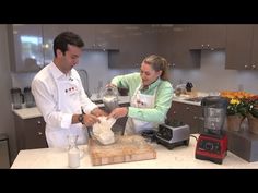 a man and woman are preparing food in the kitchen with blenders on the counter