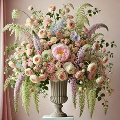 a vase filled with lots of flowers on top of a table