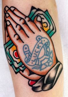 a tattoo with a praying hand on it