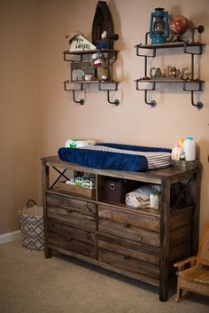 a baby crib in the corner of a room with shelves on the wall above it