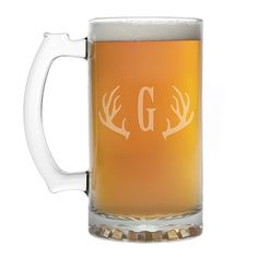 a beer mug with the initials g and deer antlers on it's side