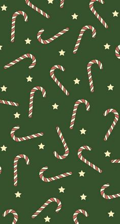 candy canes and stars on a green background for christmas wrapping paper or wallpaper