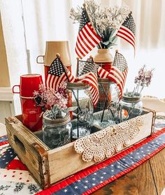 a wooden crate filled with patriotic items on top of a table