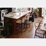 a blurry photo of a kitchen and dining room with chairs, counter tops, and tables