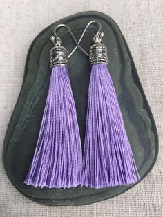 Chic light purple tassel earrings!  They would add a pop of color to any outfit for any occasion.  Dress them up or down.  They are timeless and versatile.  They are lightweight, fun and unique!The tassels measure 2 1/8” long by 1/4” wide.  They hang from simple silver ear wire hooks.  Overall drop length is about 2 1/4”.  Metal is allergy free plated silver.These are my latest creation!  I have them available in many colors!  Find them all under the category tassel earrings in my shop.Thanks fo Bohemian Purple Tassel Earrings, Elegant Purple Tassel Earrings, Bohemian Purple Dangle Tassel Earrings, Adjustable Purple Bohemian Tassel Earrings, Purple Dangle Tassel Jewelry, Purple Dangle Jewelry With Tassels, Handmade Purple Tassel Earrings As Gift, Handmade Purple Tassel Earrings For Gift, Purple Dangle Tassel Earrings With Fringe