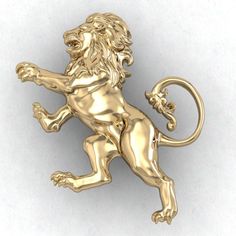 a gold lion brooch sitting on top of a white surface