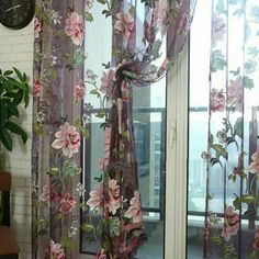 the curtains are hanging on the window sill in front of the clock and potted plant