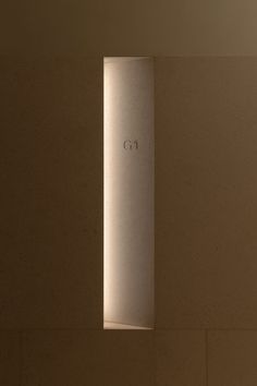 the light shines through an opening in a wall that reads g i on it