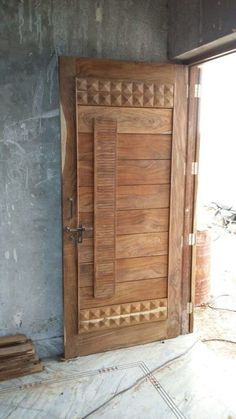 an open wooden door sitting inside of a building