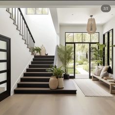 the stairs in this modern house are made of wood and have plants on each side