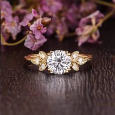 a close up of a ring with flowers in the background