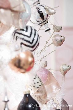 a vase filled with ornaments on top of a table