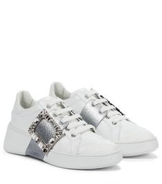 Roger Vivier's white Viv' Skate sneakers provide an opulent take on street style. Made in Italy from smooth calf leather, they have a sporty silhouette with crystal-encrusted buckles embellishing the sides. | Roger Vivier Viv' Skate leather sneakers Roger Vivier Sneakers, Roger Vivier Shoes, Skate Sneakers, Classic Bags, Roger Vivier, Sneaker Collection, Designer Sneakers, Wedge Sneaker, Leather Slip Ons