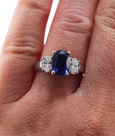 A platinum ring set with a 2.99ct sapphire and approximately 0.69ctw of G/VS diamonds. DESIGNER: None MATERIAL: Platinum GEMSTONES: Diamonds, Sapphire DIMENSIONS: Ring Size 6.5, Top is 9.3mm x 14mm MARKED/TESTED: Plat WEIGHT: 6.8 grams CONDITION: Previously Owned. Excellent Condition Lab-created Sapphire Ring With Vvs Clarity, Classic Three Stone Sapphire Ring With Cubic Zirconia, Silver Three Stone Sapphire Ring In Platinum, Platinum Three Stone Sapphire Ring Gift, Three Stone Sapphire Ring In 14k White Gold, 14k White Gold Three-stone Sapphire Ring, Brilliant Cut Sapphire Ring In Platinum, Oval Three-stone Sapphire Ring In Cubic Zirconia, Oval Three-stone Cubic Zirconia Sapphire Ring