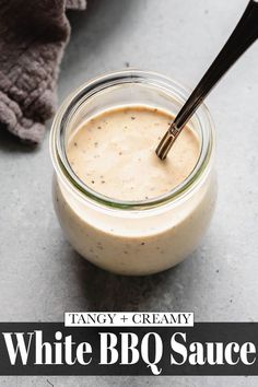 a glass jar filled with white bbq sauce on top of a gray countertop