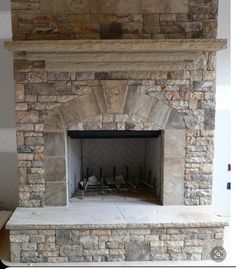 a stone fireplace with a clock above it