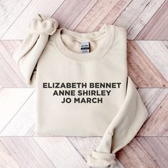 a sweater with the words elizabeth bennet, anne shriley and jo march printed on it