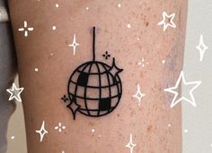 a person with a tattoo on their arm that has a globe and stars around it