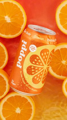 an orange soda can surrounded by sliced oranges