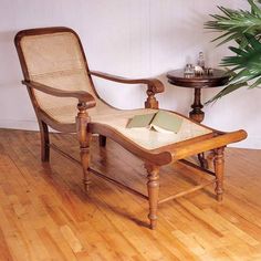 a chair and table in a room with wooden floors, one has a pillow on it