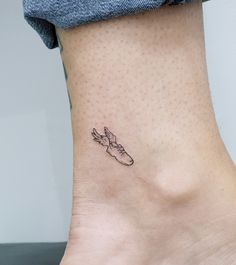 a small foot with a shoe tattoo on it's side, and the word love is