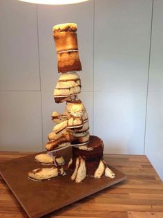 a stack of sandwiches sitting on top of a wooden cutting board next to a lamp