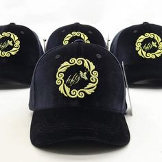 Presenting our Velvet Buzz Baseball Hat in timeless black, a sophisticated and luxurious choice in headwear. Made from pure velvet, this hat showcases our signature bee logo, intricately embroidered in glitter gold thread at the front center, encircled by a beautiful design. The back arch proudly displays our company name, Honeyfeinated, also in glitter gold thread. The adjustable bronze belt buckle features an artfully embossed bee logo. The inner lining of the hat is crafted from pure black satin, with custom tape printing of our company name, ensuring a look of opulence and charm. Luxury Embroidered Snapback Baseball Cap, Women Classic Style, Back Arch, Luxury Six-panel Baseball Cap With Embroidered Logo, Black Six-panel Trucker Hat With Embroidered Logo, Black Six-panel Fitted Hat With Embroidered Logo, Black Short-brimmed Baseball Cap With Embroidered Logo, Custom Tape, Bee Logo