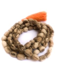 Tulsi (Tulasi) japa mala made from hand carved beads, hand knotted on white cotton thread, in Vrindavan, India. The beads are approximately 6mm to 9mm, with Large orange-colored cotton tassel. Total length is approximately 40 - 48 inches. Vrindavan grown, Vrindavan crafted.™ Use japa mala necklace as is, either as a necklace, prayer beads or a bracelet wrapped approximately six times around your wrist or use the beads for other crafting projects. The name "Tulasi" means "she who is incomparable. Bohemian Hand-strung Mala For Rituals, Bohemian Mala With Wooden Beads For Festivals, Traditional Handmade Mala For Meditation, Traditional Wooden Beads For Rituals, Holistic Wooden Beads Mala For Rituals, Adjustable Artisan Mala For Rituals, Bohemian Mala With Wooden Beads For Puja, Bohemian Wooden Beads Mala For Puja, Traditional Wooden Beads Mala For Puja