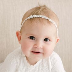 Handmade in the USA The Eliza Headband is made with a soft elastic band in light ivory. Detailed with a darling floral applique for a delicate look. Pairs beautifully with the Eliza Christening Gown & Dress. Elastic Lace Band Floral Applique Detail **Please note that the headband should be worn under adult supervision and contains small parts** White Matching Headband For Baptism, Adjustable White Lace Hair Accessories, Elegant Adjustable Hair Accessories For Baptism, White Hair Accessories With Matching Headband For Baptism, White Adjustable Hair Accessories, Cream Headband For Baptism, Cream Baptism Headband Hair Accessory, Fitted White Headband For Spring, White Fitted Headband For Spring