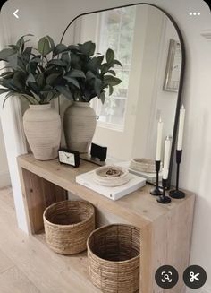 a mirror and some baskets on a table