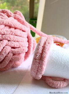 a pile of pink towels sitting on top of a table