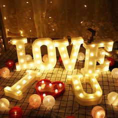 the letters love spelled out in front of candles