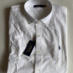 100% Authentic Mens Ralph Lauren Jersey Long Sleeve Shirt (Msrp $125). This Shirt Is Brand New With Tags! Polo Ralph Lauren's Piece Combines The Polished Look Of Our Signature Spread-Collar Oxford Shirt With Soft Cotton Jersey. Color: White Buttoned Placket Signature Ralph Lauren Embroidered Pony At The Left Chest Medium-Spread Collar Long Sleeves With Buttoned Barrel Cuffs Split Pleated Back Yoke Ensures Smooth, Contoured Shoulders 100% Cotton Casual White Dress Shirt With Casual Collar, Casual White Collared Dress Shirt, White Casual Dress Shirt With Spread Collar, White Polo Shirt With Buttons, Classic Shirt With Casual Collar, Classic Tops With Casual Collar And Buttons, White Casual Dress Shirt With Placket, Classic Tops With Buttons And Casual Collar, Spring Polo Collar Shirt With Buttons