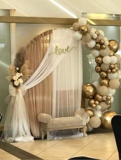 a room decorated with balloons and decorations for a wedding or bridal party in gold, white and silver colors