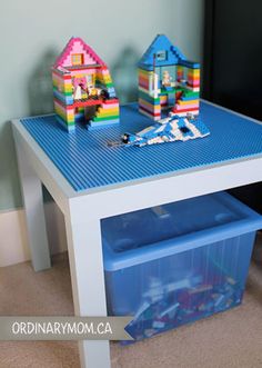 a table with legos on it and a plastic storage bin underneath the table top