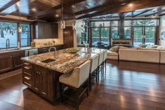 a large kitchen with an island in the middle and lots of counter space on each side