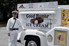 a man standing next to an ice cream truck