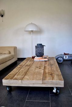 a living room with a couch, coffee table and other items on the black tile floor