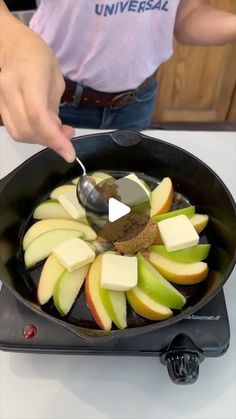 someone is cooking apples and spices in a skillet