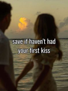 a man and woman standing next to each other in front of the ocean with text saying save if haven't had your first kiss