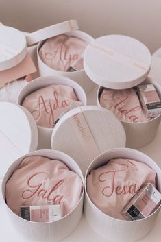 six round boxes with personalized items in them sitting on a white countertop next to each other