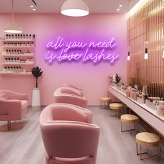 the interior of a nail salon with pink chairs and neon signs on the wall above them